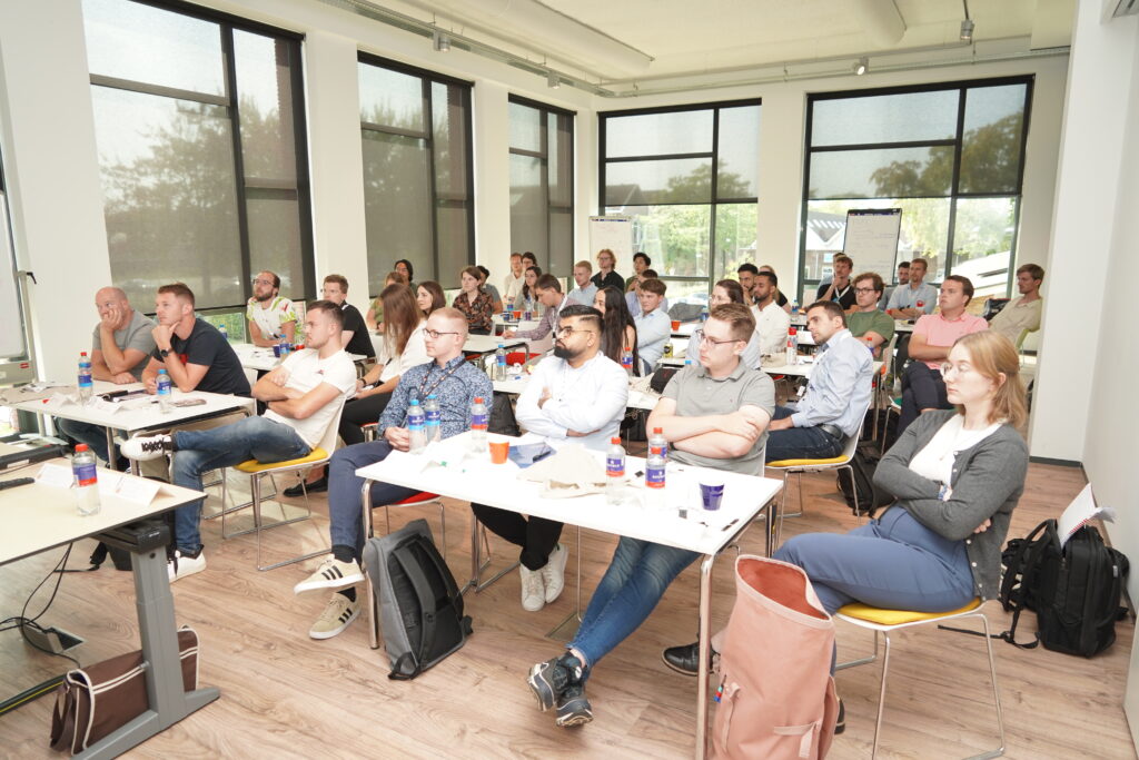 A large group of young students sitting in class following the lecture